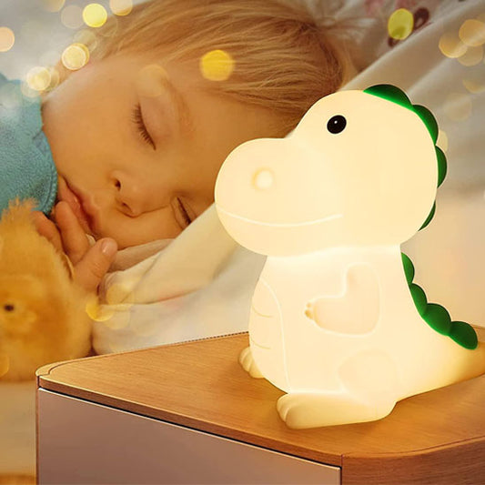 Veilleuse bébé led dinosaure près d'un enfant endormi