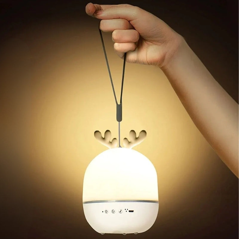 Veilleuse musicale bébé portable USB tenue à la main