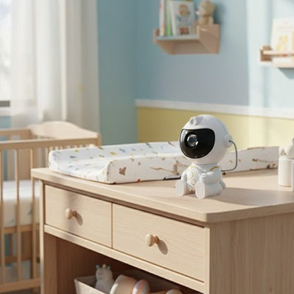 Veilleuse projection astronaute posée sur commode dans chambre d'enfant